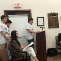 Eli Greenberg speaking to Olmos Park Mayor and City Council on behalf of Olmos Park Youth Commission with Sam Spezia-Lindner and Henry Satel waiting to speak.